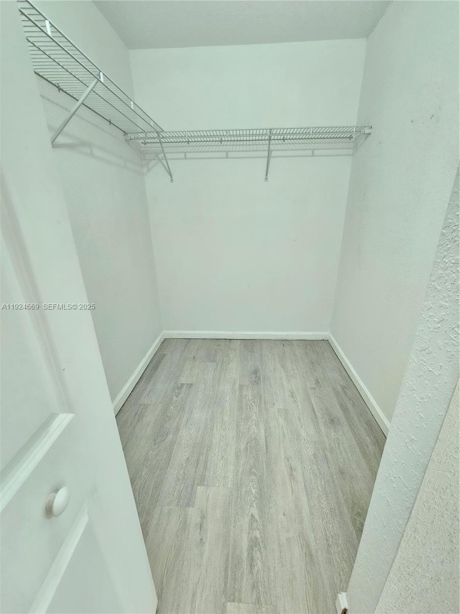 15447 Southwest 151st Street Miami, FL 33196 - Photo 16 of 25 a view of a room with racks on the wall
