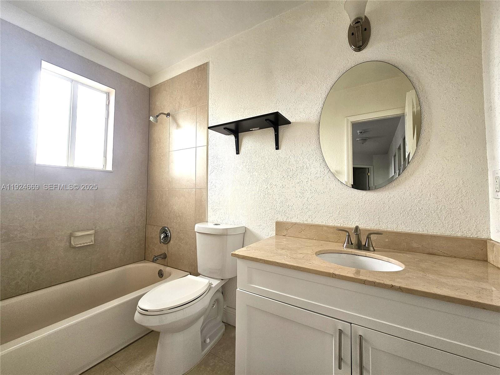 15447 Southwest 151st Street Miami, FL 33196 - Photo 20 of 25 a bathroom with a granite countertop sink mirror toilet and bathtub