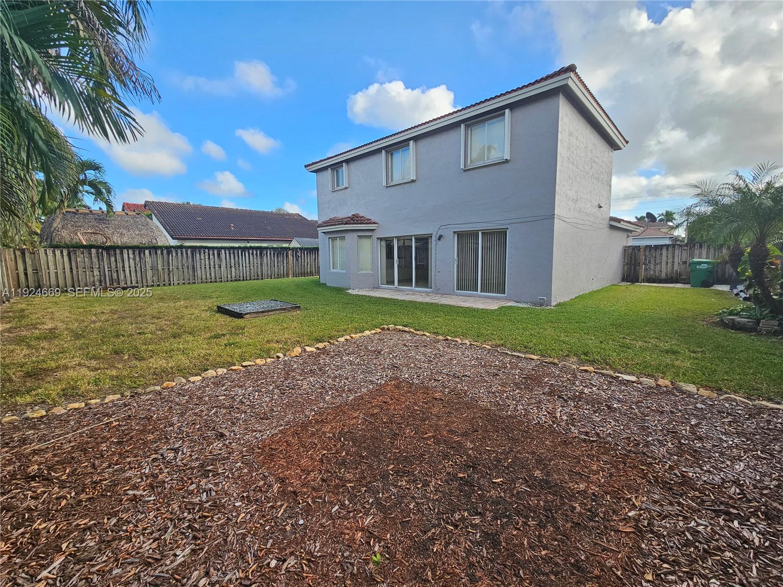 15447 Southwest 151st Street Miami, FL 33196 - Photo 23 of 25 a view of a house with a yard