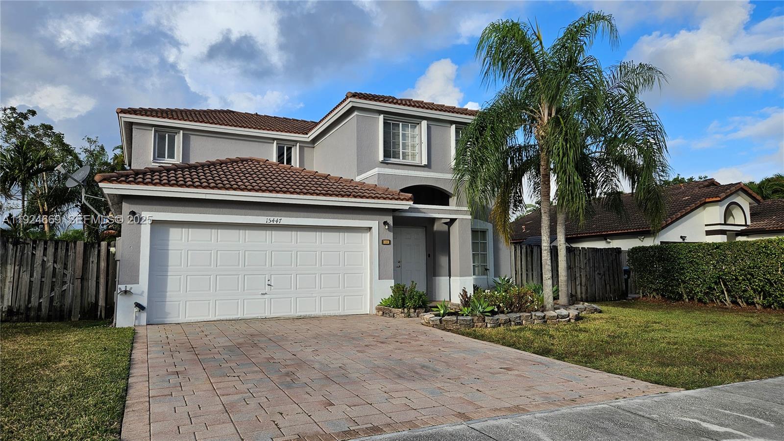 15447 Southwest 151st Street Miami, FL 33196 - Photo 25 of 25 a front view of a house with a yard and garage