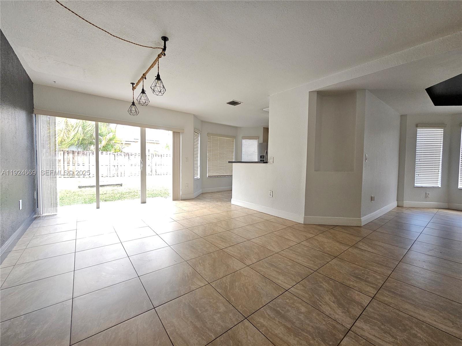 15447 Southwest 151st Street Miami, FL 33196 - Photo 5 of 25 a view of an empty room with a window