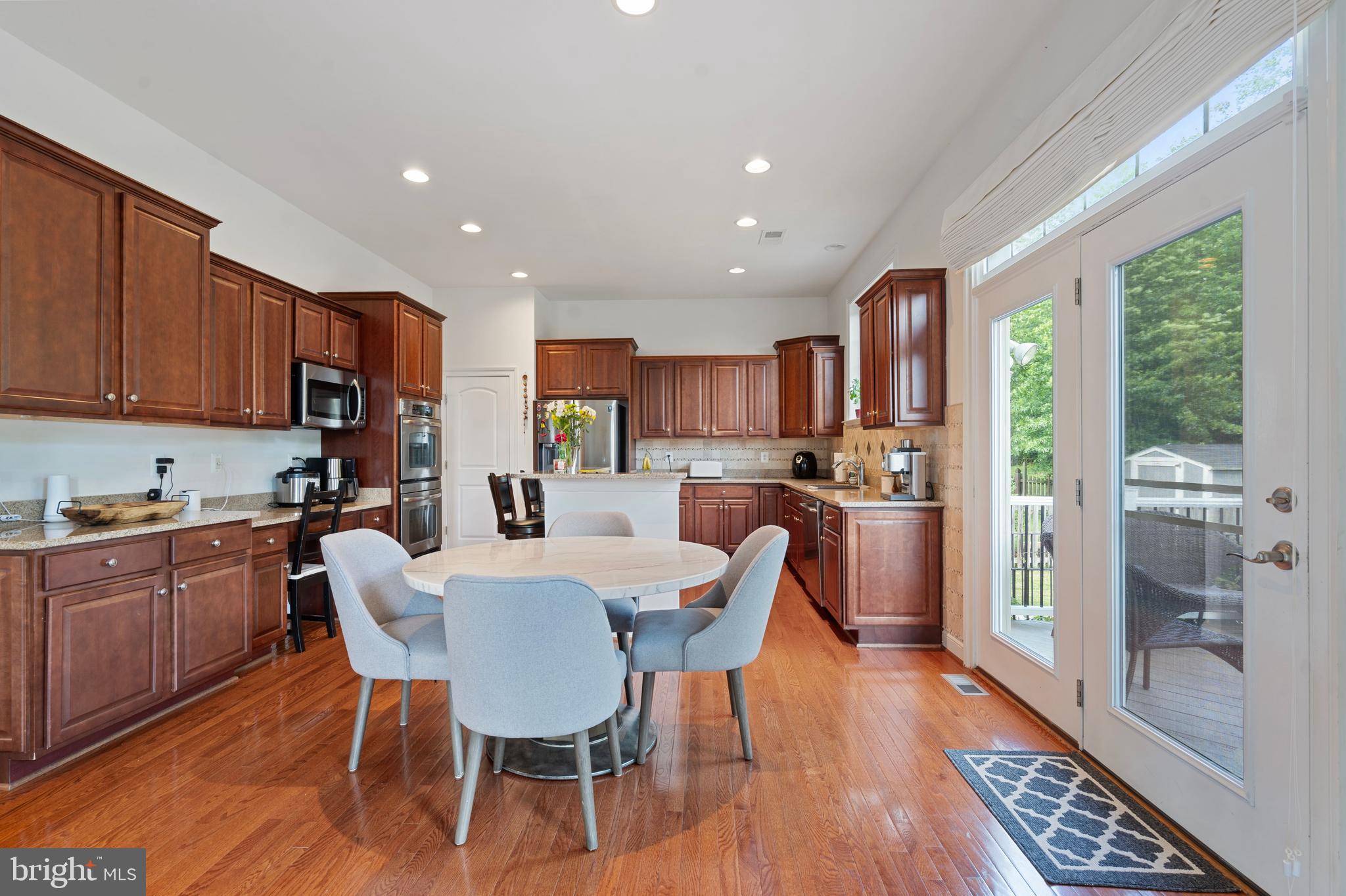 42735 Macauley Place Ashburn, VA 20148 - Photo 13 of 39 a view of a dining room with furniture window and wooden floor