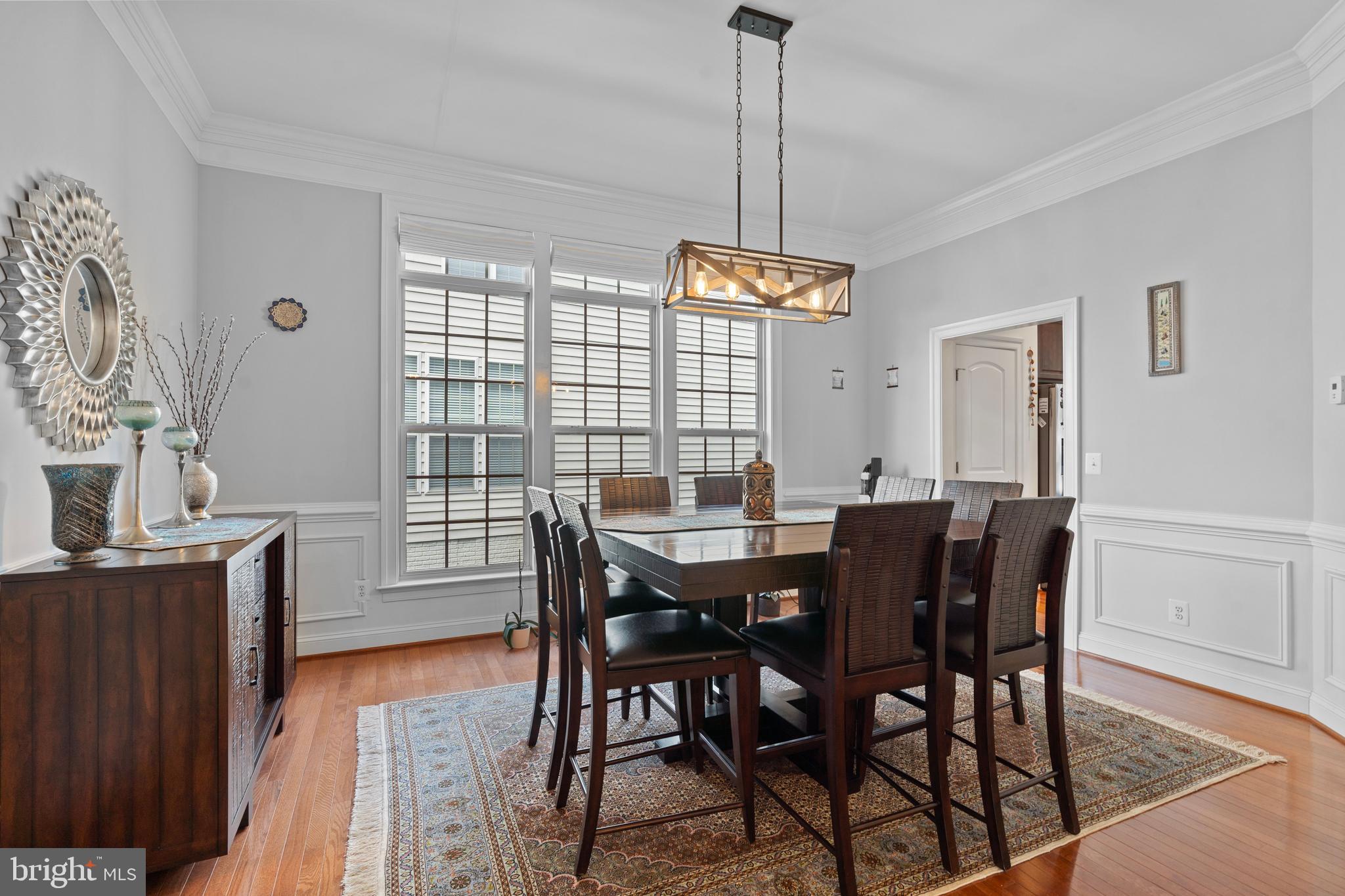 42735 Macauley Place Ashburn, VA 20148 - Photo 14 of 39 a view of a dining room with furniture window and wooden floor