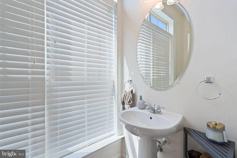 42735 Macauley Place Ashburn, VA 20148 - Photo 16 of 39 a bathroom with a sink a mirror and a window