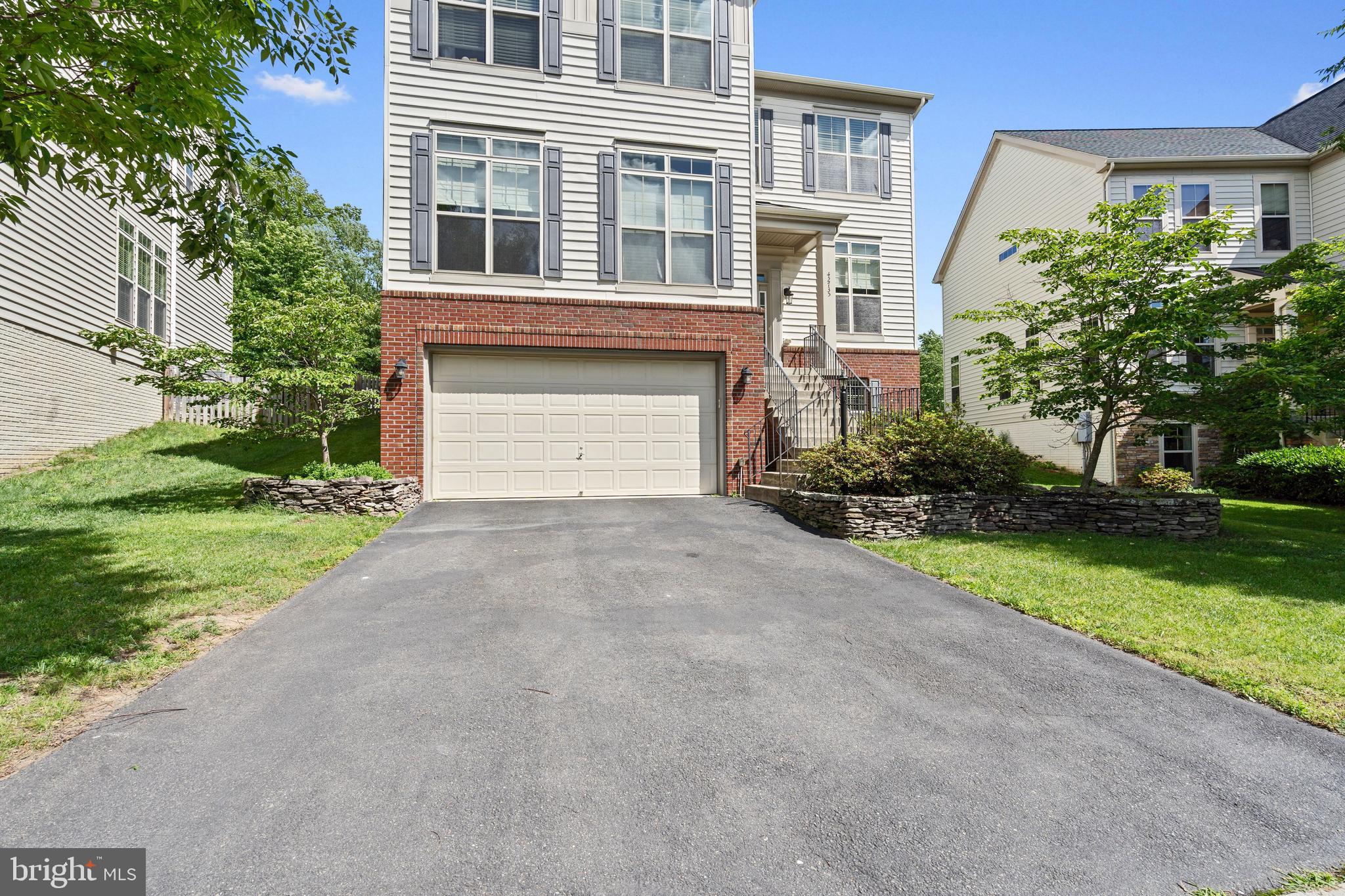 42735 Macauley Place Ashburn, VA 20148 - Photo 2 of 39 front view of house with a yard