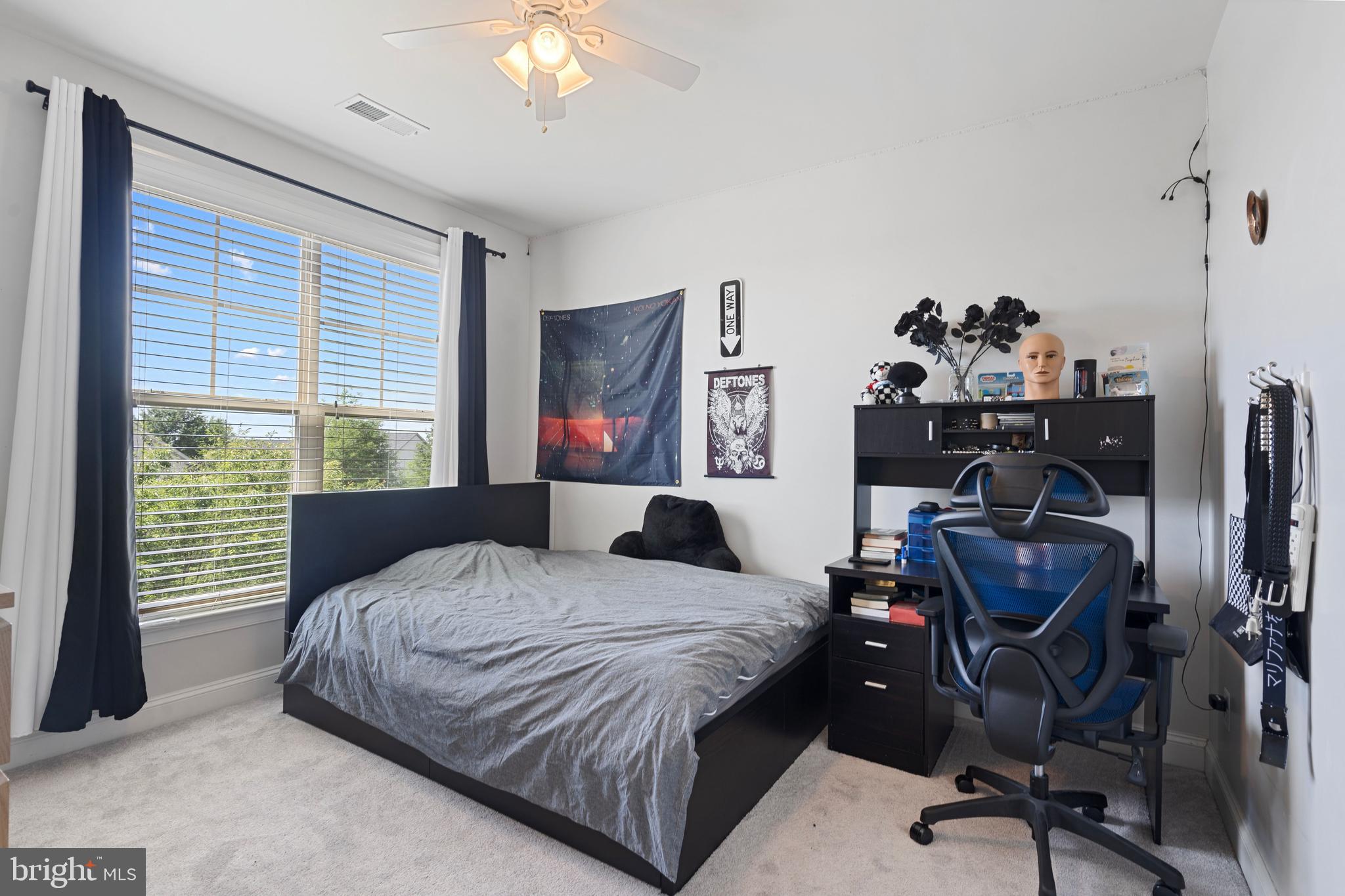 42735 Macauley Place Ashburn, VA 20148 - Photo 24 of 39 a bedroom with a bed and a chandelier