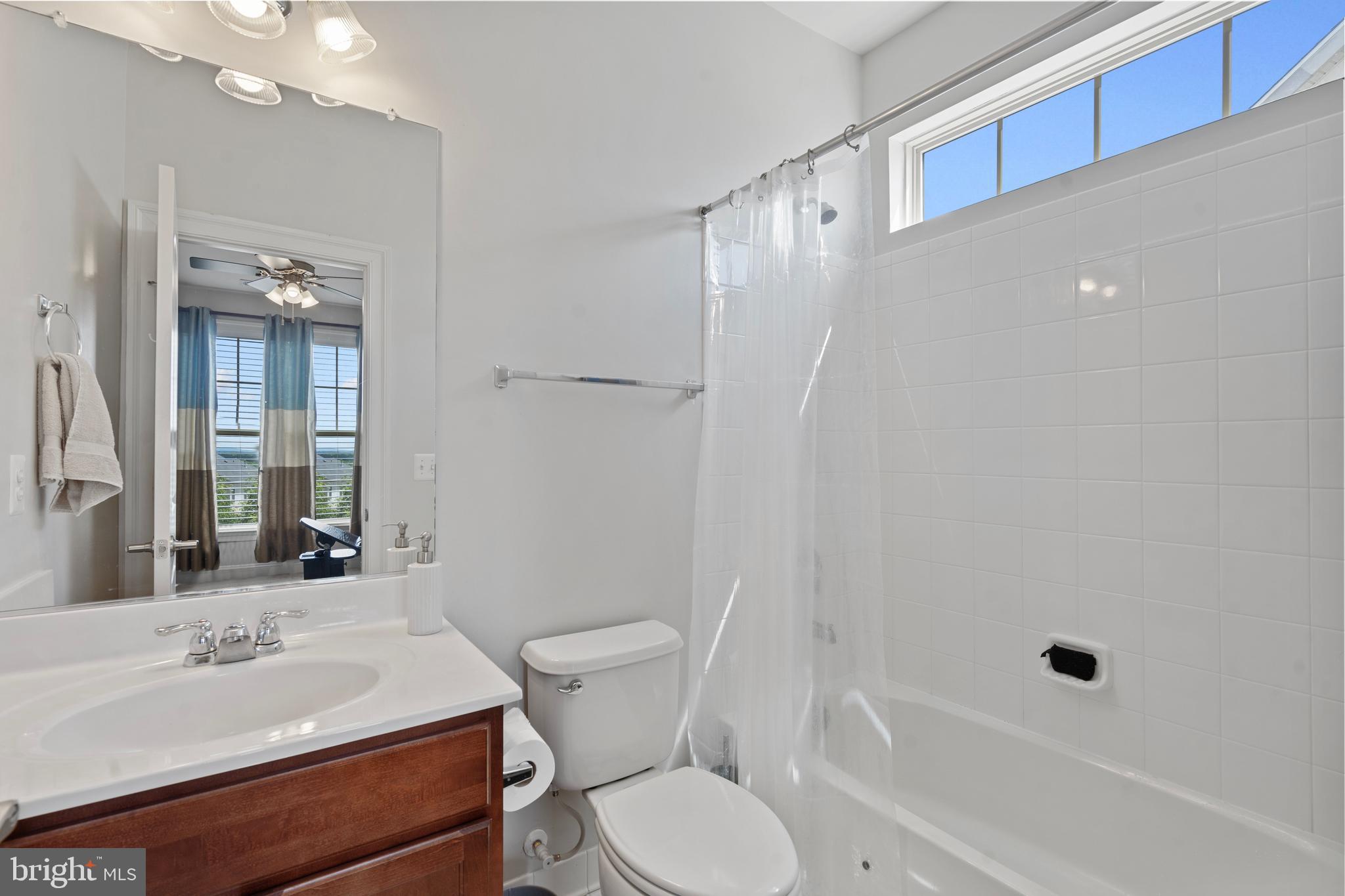 42735 Macauley Place Ashburn, VA 20148 - Photo 29 of 39 a bathroom with a sink toilet vanity and shower