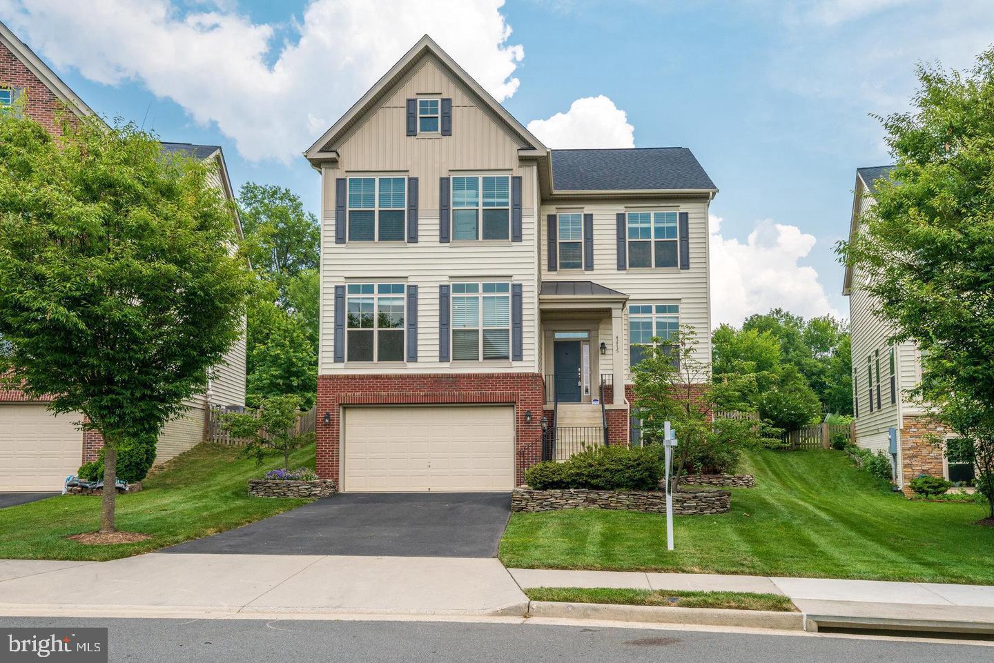 42735 Macauley Place Ashburn, VA 20148 - Photo 3 of 39 a front view of a house with a yard