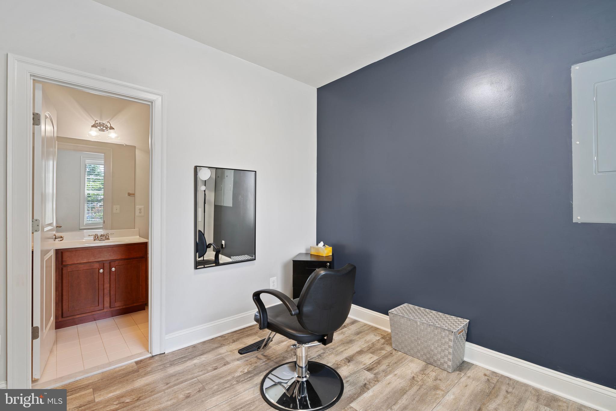 42735 Macauley Place Ashburn, VA 20148 - Photo 31 of 39 a bedroom with a bed and wooden floor