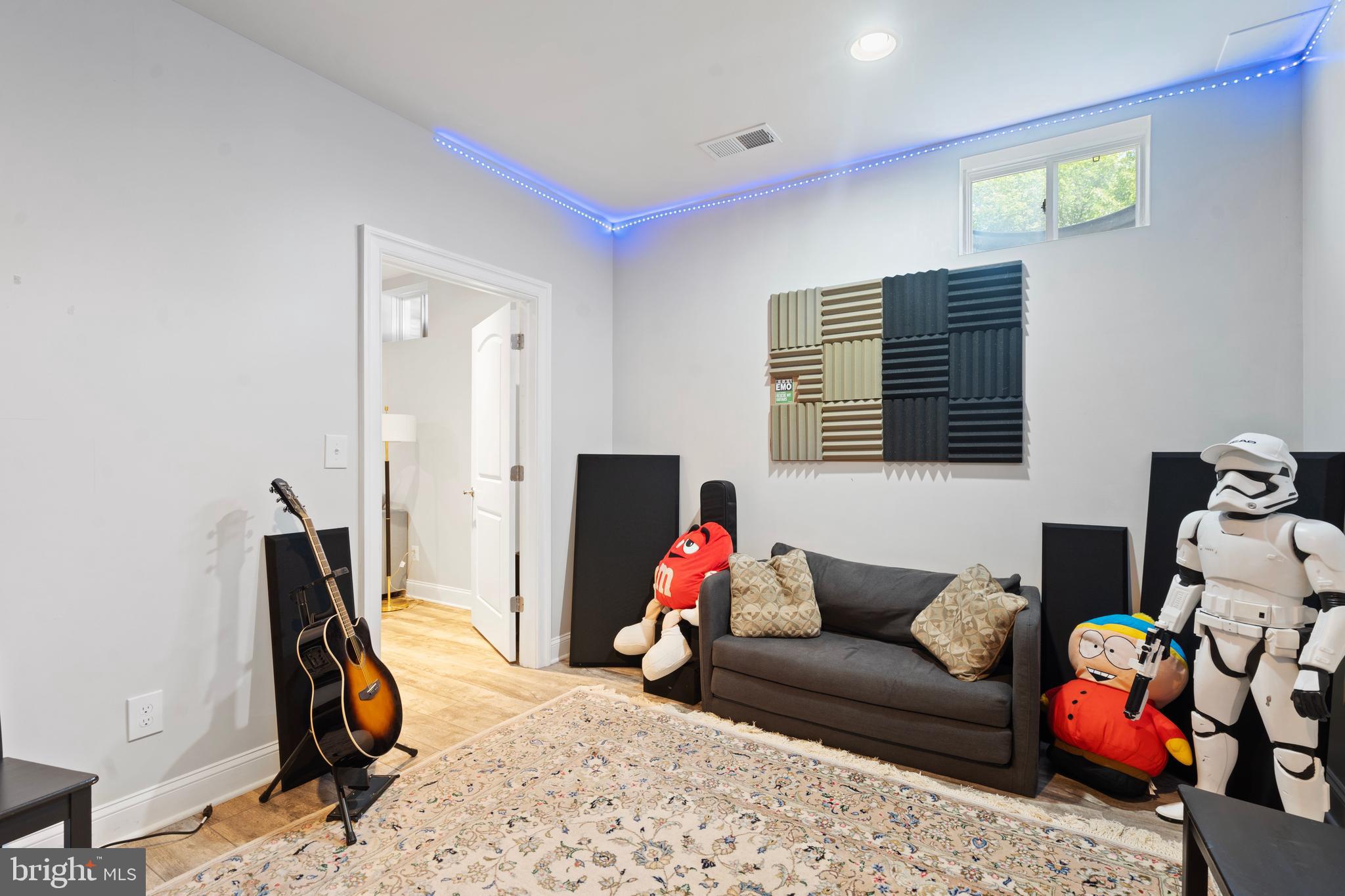 42735 Macauley Place Ashburn, VA 20148 - Photo 34 of 39 a living room with furniture a flat screen tv and a window
