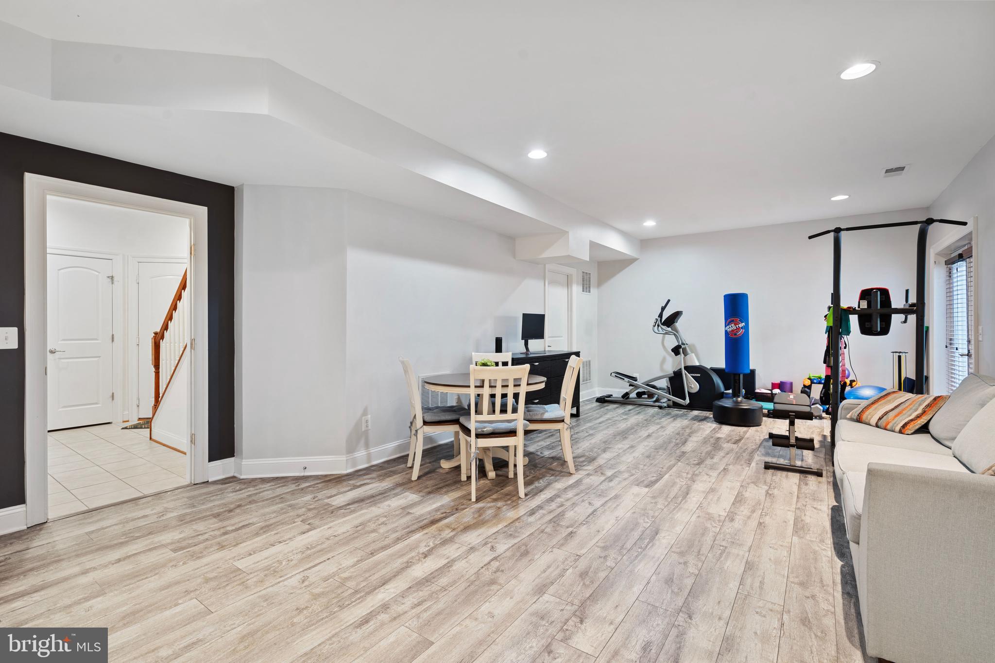 42735 Macauley Place Ashburn, VA 20148 - Photo 35 of 39 a living room with furniture a window and wooden floor