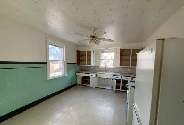 a kitchen with refrigerator a stove and cabinets