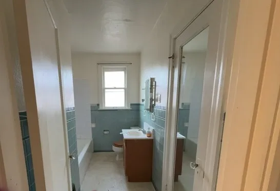 a bathroom with a bathtub and window