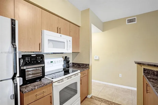 a living room with furniture a chandelier and a window