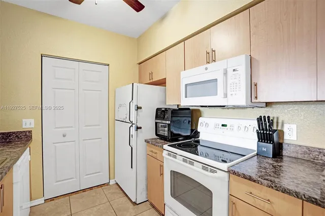 a kitchen with stainless steel appliances white cabinets and a stove top oven