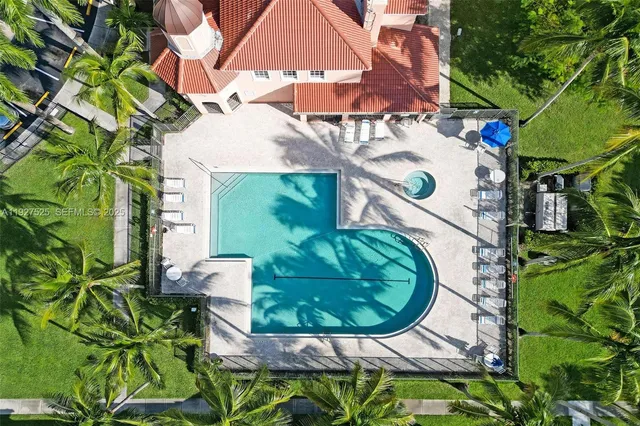 an aerial view of residential houses with outdoor space and lake view