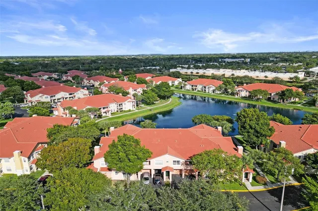 an aerial view of house with yard and mountain view in back yard