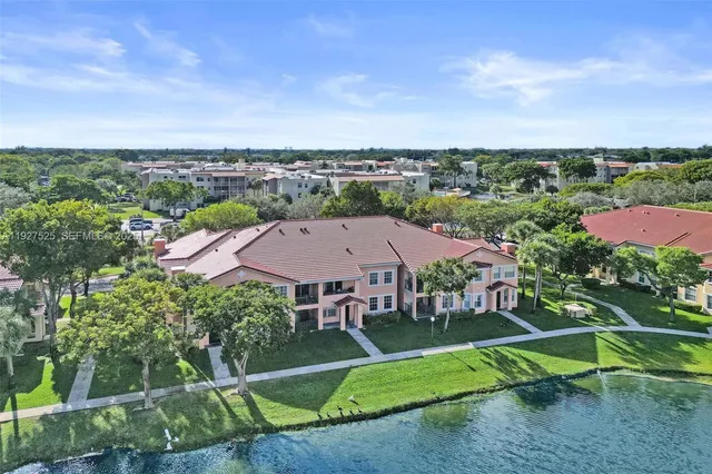 a view of a lake with houses in the back