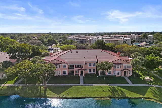 a view of a house with a big yard and potted plants