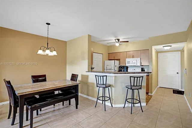 a view of a dining room with furniture and a chandelier