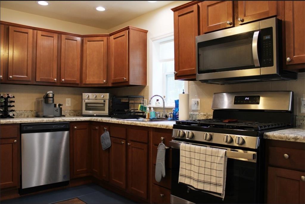 157 East College Street Canonsburg, PA 15317 - Photo 2 of 25 a kitchen with stainless steel appliances a stove a sink a microwave and cabinets