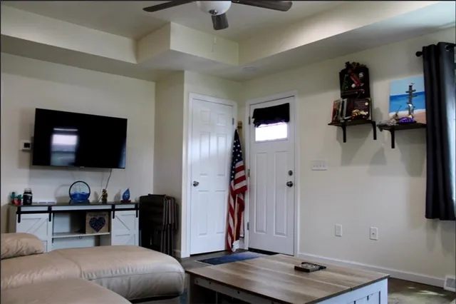 a bedroom with furniture and a flat screen tv