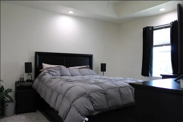 a bedroom with a bed and a window