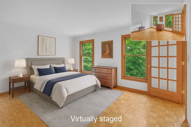 a spacious bedroom with a bed and a large window