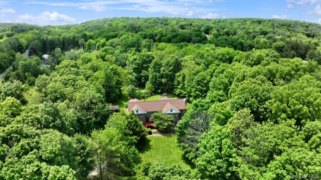 an aerial view of a house with a yard