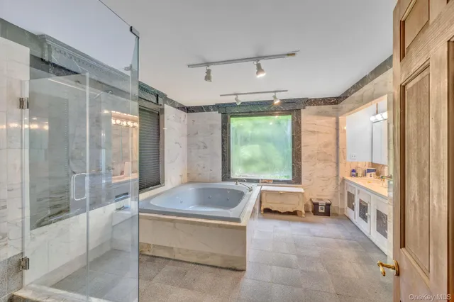 a large spacious bathroom with a large tub and shower