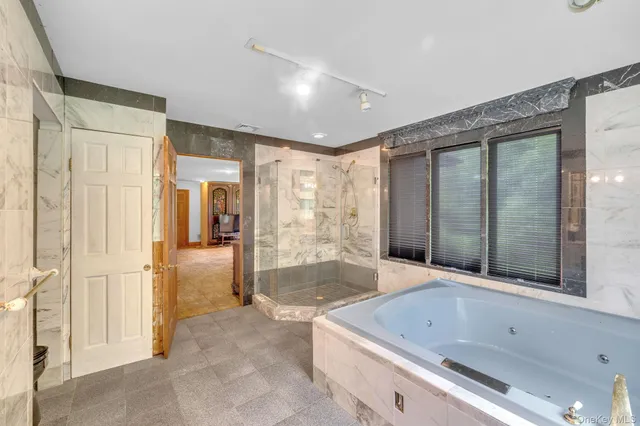 a bathroom with a tub shower and sink