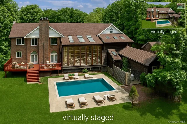 a aerial view of a house with swimming pool garden and patio