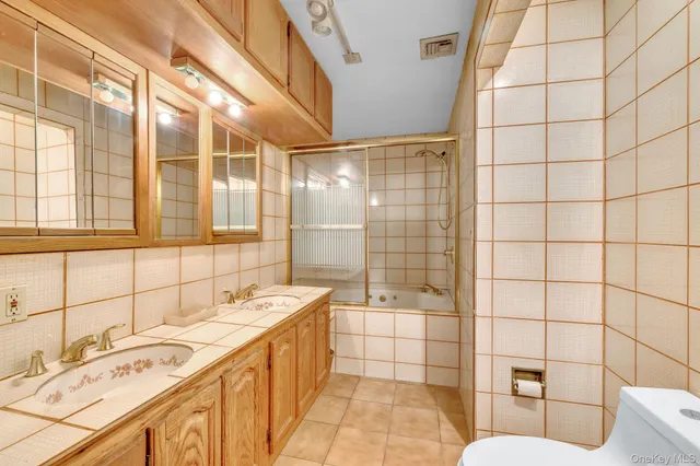 a bathroom with a sink shower and a mirror