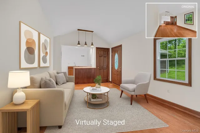 a view of a room with wooden floor staircase and a hallway