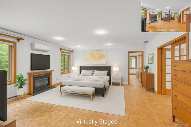 a spacious bedroom with a bed a flat screen tv and a couch