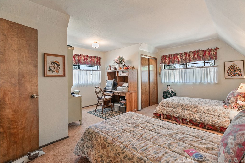 329 Grass Valley Road Lake Arrowhead, CA 92352 - Photo 15 of 31 a bedroom with a bed table and a window