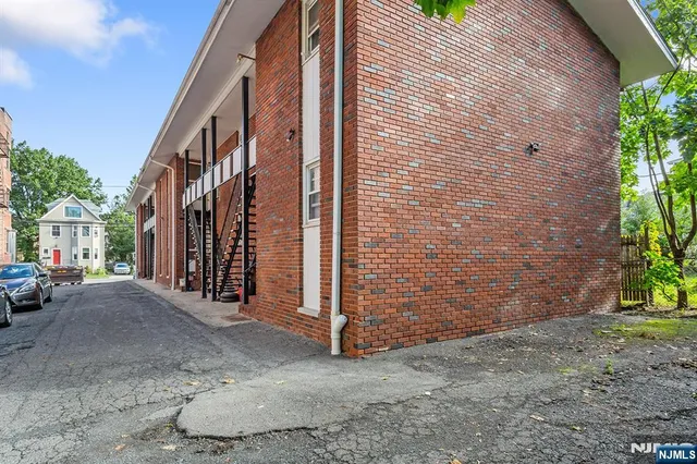 a view of a street with brick walls