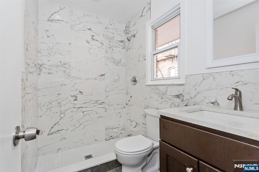 86 Chestnut Street Rutherford, NJ 07070 - Photo 4 of 20 a bathroom with a sink toilet and shower