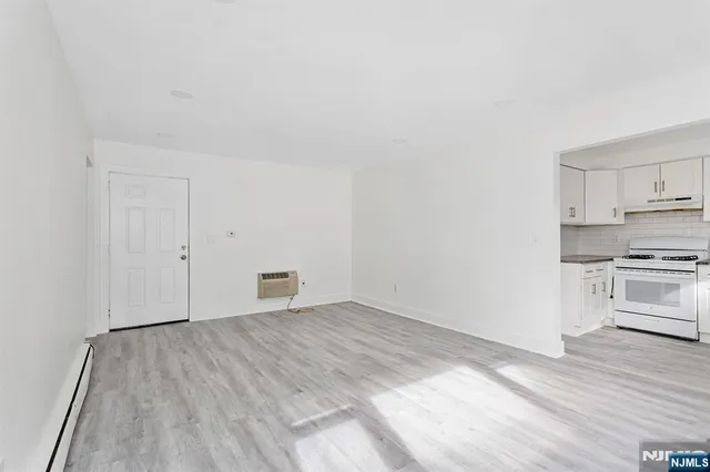 a view of a kitchen with wooden floor and electronic appliances