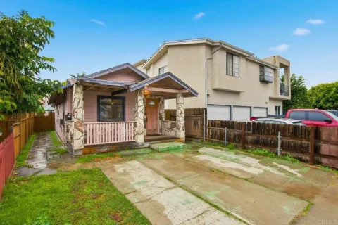 a front view of a house with a yard outdoor seating and barbeque oven