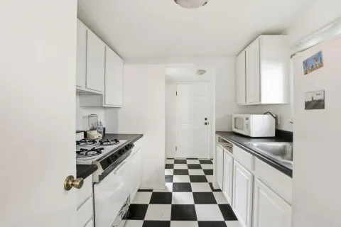 a kitchen with granite countertop a sink and a stove