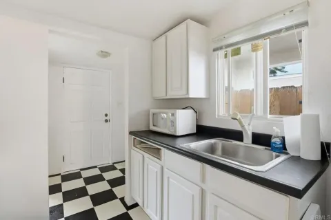 a kitchen with granite countertop a sink and a window