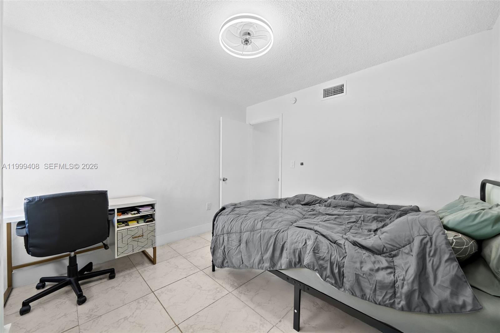 515 Southwest 3rd Street, Unit 6 Miami, FL 33130 - Photo 12 of 19 a bedroom with a bed and a chair