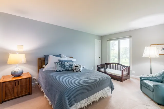 a bedroom with two beds and a lamp