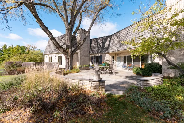 a view of a house with backyard and sitting area