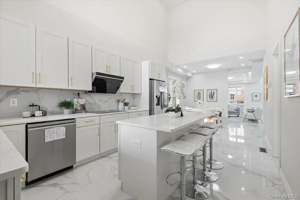 a kitchen with stainless steel appliances kitchen island granite countertop a sink and cabinets