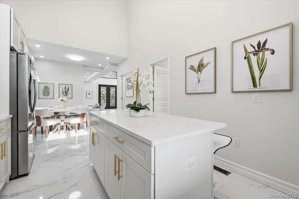 a kitchen with kitchen island a stove a table and chairs
