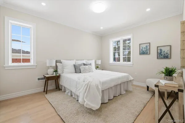 a bedroom with a bed and windows