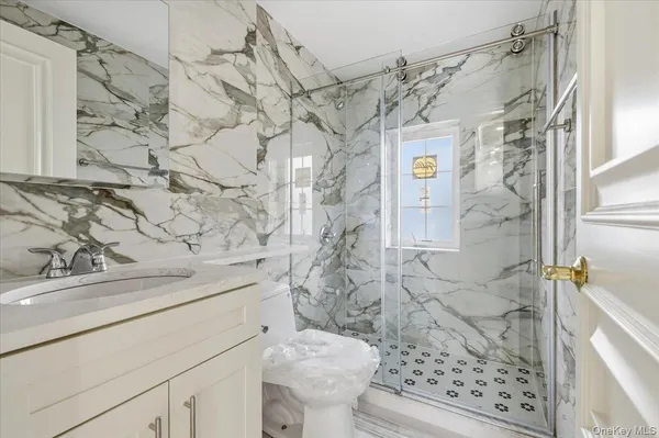 a bathroom with a sink toilet and shower