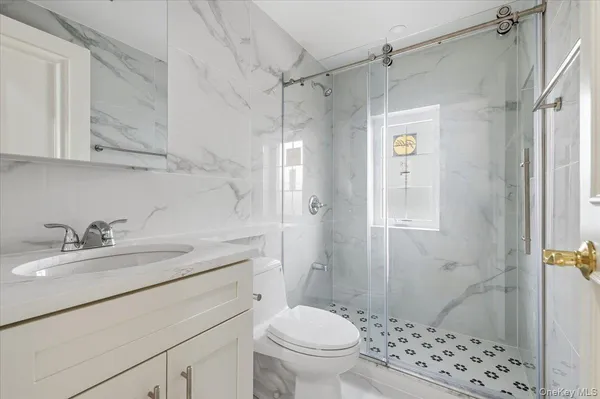 a bathroom with a sink toilet and shower